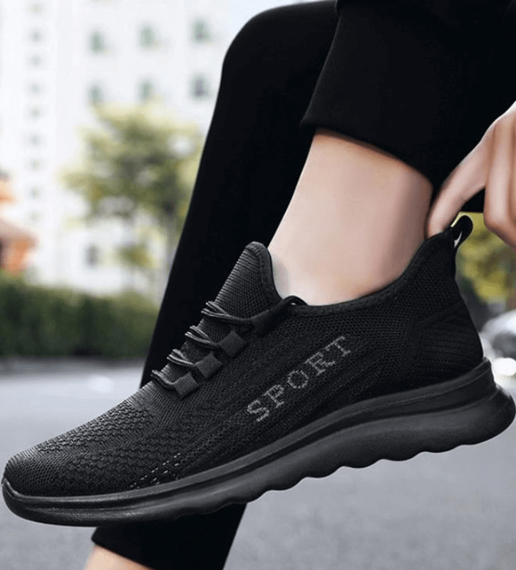 Stylish breathable black lace-up sneakers for men, featuring mesh upper and flexible sole, perfect for comfortable casual wear.